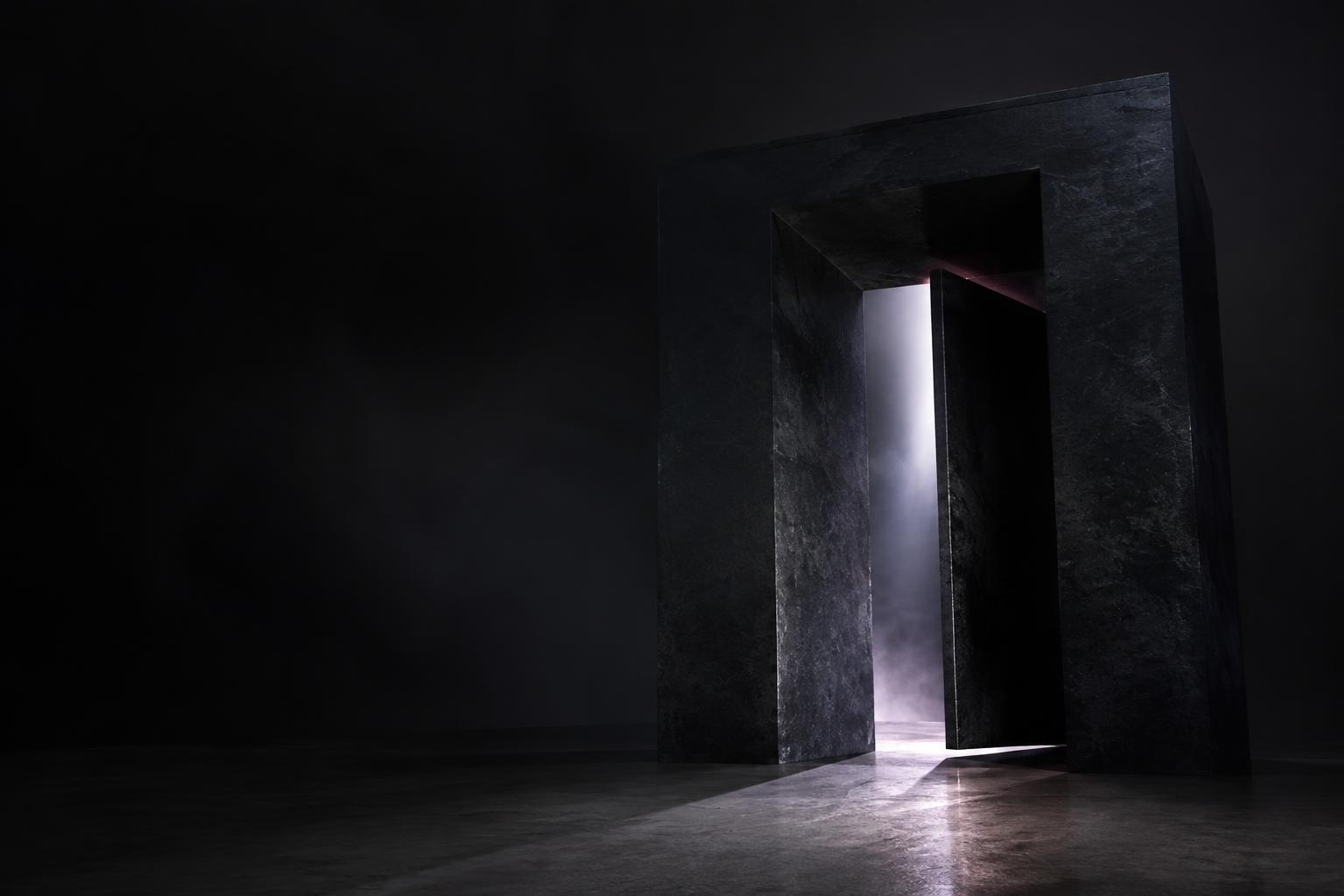 Sculptural stone doorway opening onto a shaft of light